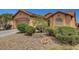 Low angle of a tan home showcasing its desert landscaping at 3544 Tack St, Las Vegas, NV 89122