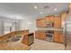 Kitchen and breakfast bar with stainless steel appliances and granite counters at 3544 Tack St, Las Vegas, NV 89122