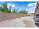 Backyard features a concrete block fence, desert landscaping, and patio space at 3752 Calle De Rio Ave, Las Vegas, NV 89115