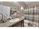 Well-lit bathroom with a single vanity and shower-tub combo at 3752 Calle De Rio Ave, Las Vegas, NV 89115