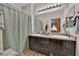 Bathroom with double sink vanity, decorative mirror, and shower at 3752 Calle De Rio Ave, Las Vegas, NV 89115