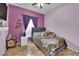 Comfortable bedroom with a queen-sized bed and vibrant purple walls at 3752 Calle De Rio Ave, Las Vegas, NV 89115