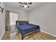 Cozy bedroom features a ceiling fan, window, and warm-toned tile flooring at 3752 Calle De Rio Ave, Las Vegas, NV 89115