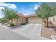 Inviting single-story home with landscaped front yard and a spacious driveway leading to a two-car garage at 3752 Calle De Rio Ave, Las Vegas, NV 89115