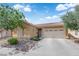 Well-kept single-story house with a neutral facade, neat front garden, and attached two-car garage at 3752 Calle De Rio Ave, Las Vegas, NV 89115