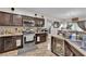 Well-lit kitchen with stainless steel appliances, and dark wood cabinets at 3752 Calle De Rio Ave, Las Vegas, NV 89115