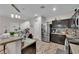 Well-equipped kitchen featuring stainless steel appliances, dark cabinetry, and stylish tile flooring at 3752 Calle De Rio Ave, Las Vegas, NV 89115