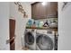 Laundry room with modern washer and dryer units and storage cabinets at 3752 Calle De Rio Ave, Las Vegas, NV 89115