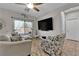 Cozy living room featuring a large window, a ceiling fan, tile flooring, and comfortable seating arrangement at 3752 Calle De Rio Ave, Las Vegas, NV 89115