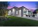 Charming backyard with an outdoor seating area, lush artificial turf, and stylish architectural details at 42 Ravenswood Ave, Las Vegas, NV 89141