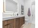 Stylish bathroom with a glass shower, wooden vanity, illuminated mirror, and modern fixtures for a spa-like experience at 42 Ravenswood Ave, Las Vegas, NV 89141