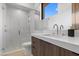 The bathroom has modern fixtures, wood cabinets, and a stand up shower at 42 Ravenswood Ave, Las Vegas, NV 89141