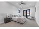 This bedroom features neutral decor, a ceiling fan, and access to a balcony at 42 Ravenswood Ave, Las Vegas, NV 89141