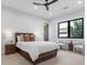 This cozy bedroom features a modern ceiling fan, neutral decor, and a window with a view of the outdoors at 42 Ravenswood Ave, Las Vegas, NV 89141