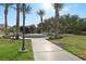 Beautiful community park featuring a central fountain, green lawns, and swaying palm trees on a sunny day at 42 Ravenswood Ave, Las Vegas, NV 89141