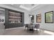 Bright dining area with modern lighting, custom built-ins, and a view of the backyard at 42 Ravenswood Ave, Las Vegas, NV 89141