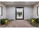 Inviting entryway featuring decorative plants leading to a modern interior at 42 Ravenswood Ave, Las Vegas, NV 89141
