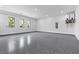 Spacious and modern garage with a sleek epoxy floor, ample lighting, and clean white walls at 42 Ravenswood Ave, Las Vegas, NV 89141