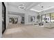Open-concept living area featuring hardwood floors and contemporary chandeliers at 42 Ravenswood Ave, Las Vegas, NV 89141