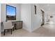This hallway features a built-in desk, wood floors, and glass doors at 42 Ravenswood Ave, Las Vegas, NV 89141