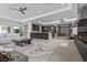 Bright open-concept living room showcasing a modern fireplace, gourmet kitchen, and stylish contemporary furnishings at 42 Ravenswood Ave, Las Vegas, NV 89141