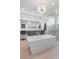 The main bathroom boasts a contemporary chandelier and separate vanities, offering plenty of counter space at 42 Ravenswood Ave, Las Vegas, NV 89141