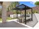 Outdoor kitchen with built in grill and seating under a pergola at 42 Ravenswood Ave, Las Vegas, NV 89141