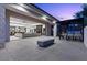 Expansive outdoor living space with a fire feature, bar seating, and seamless indoor-outdoor transition at 42 Ravenswood Ave, Las Vegas, NV 89141