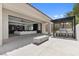 This outdoor living space has an outdoor kitchen, bar seating, and a fire pit at 42 Ravenswood Ave, Las Vegas, NV 89141