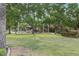 Community playground surrounded by lush greenery and mature trees offers a delightful recreational space at 42 Ravenswood Ave, Las Vegas, NV 89141