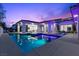 Stunning pool featuring an integrated spa and modern design elements, illuminated beautifully at twilight at 42 Ravenswood Ave, Las Vegas, NV 89141