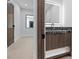 Stylish powder room featuring wood vanity with marble countertop and backsplash, backlit mirror, and wood accents at 42 Ravenswood Ave, Las Vegas, NV 89141