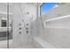 Luxurious marble shower with multiple shower heads and bench seating at 42 Ravenswood Ave, Las Vegas, NV 89141