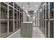 A custom walk-in closet offers ample storage, well-organized shelving and full-length mirrored doors at 42 Ravenswood Ave, Las Vegas, NV 89141