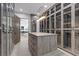 This expansive walk-in closet has custom cabinetry, a center island and plenty of space for storage at 42 Ravenswood Ave, Las Vegas, NV 89141