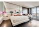 Bright bedroom showcasing sleek floors, a large mirror, and a comfortable lounge area at 4381 W Flamingo Rd # 5220, Las Vegas, NV 89103