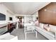 Spacious living room featuring a comfortable sofa, a glass table, and city views from the balcony at 4381 W Flamingo Rd # 5220, Las Vegas, NV 89103