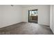 Bedroom featuring neutral carpet, sliding glass door to a private patio, and bright, white walls at 45 Maleena Mesa St # 223, Henderson, NV 89074