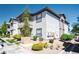 A well-maintained two-story condo featuring neutral stucco and brown trim, set amongst desert landscaping at 45 Maleena Mesa St # 223, Henderson, NV 89074
