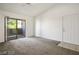 A bright living room with sliding glass door, neutral carpet, and a ceiling fan for added comfort at 45 Maleena Mesa St # 223, Henderson, NV 89074