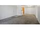 Bright living room with neutral carpet flooring and open access to the dining area and kitchen beyond at 45 Maleena Mesa St # 223, Henderson, NV 89074