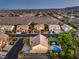Expansive aerial view of a residential area featuring homes with pools and landscaping against a mountain backdrop at 4737 Barcelona Ridge Ct, Las Vegas, NV 89129