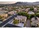 Aerial view of the neighborhood showcasing its homes, landscaping, and proximity to the majestic mountains at 4737 Barcelona Ridge Ct, Las Vegas, NV 89129