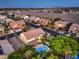 Stunning aerial view of property featuring a backyard pool, tennis court and mature trees at 4737 Barcelona Ridge Ct, Las Vegas, NV 89129