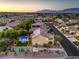 Aerial view showcases backyard with pool, tennis court, privacy landscaping, and outdoor dining area at 4737 Barcelona Ridge Ct, Las Vegas, NV 89129