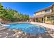 This backyard features a pool, slide, hot tub, and patio for entertaining at 4737 Barcelona Ridge Ct, Las Vegas, NV 89129