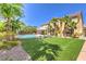 Spacious backyard featuring an outdoor pool, lounge chairs, and lush landscaping at 4737 Barcelona Ridge Ct, Las Vegas, NV 89129