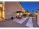 Backyard patio with sleek outdoor dining set, stone pavers, and convenient access to storage, perfect for gatherings at 4737 Barcelona Ridge Ct, Las Vegas, NV 89129