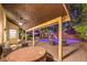 Covered patio with a hot tub overlooking a backyard pool, patio furniture, and landscaped greenery at 4737 Barcelona Ridge Ct, Las Vegas, NV 89129