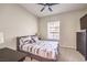 Cozy bedroom with a comfortable bed, dark wood furniture, neutral decor, and a window with blinds at 4737 Barcelona Ridge Ct, Las Vegas, NV 89129